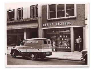 Old photograph showing a van parked outside of a Morphy Richards shop with a man carrying boxes outside