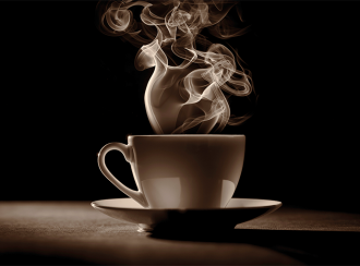 A cup of coffee with steam rising from it